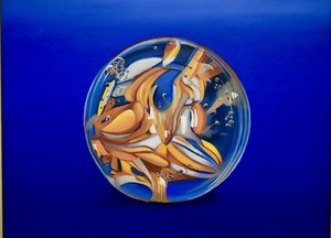 A painting of a clear glass marble filled with swirling amber, white, and blue patterns, set against a deep blue background.