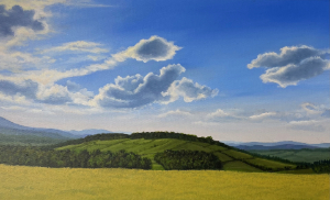 This is a bright landscape painting showing a large, central green hill covered with trees on its lower half, sitting above a field of golden-yellow grass. The scene is set under a vast blue sky filled with bright, sculptural white clouds, with layers of blue-green mountains visible in the distant background.